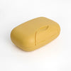A smooth, yellow portable travel soap box with a rounded design.