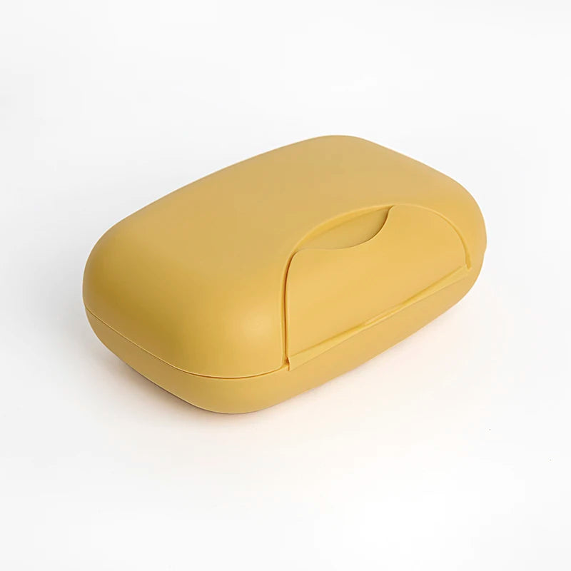 A smooth, yellow portable travel soap box with a rounded design.