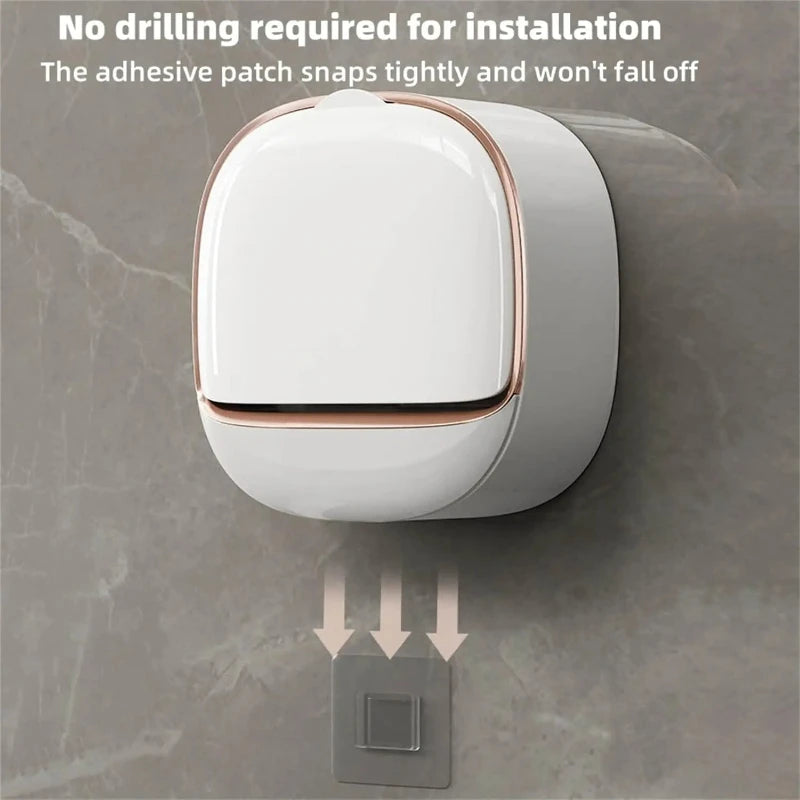 A white wall-mounted soap holder with a lid is installed on a gray marble surface.