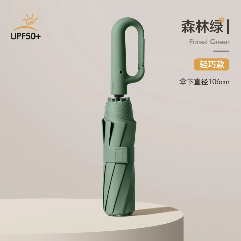 A light green automatic folding umbrella with a reinforced shaft is shown standing on a surface.
