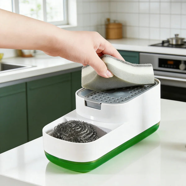 A hand is placing a sponge into a white countertop soap dispenser with a green base.