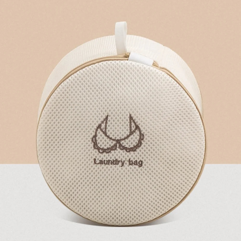 A beige reusable zippered laundry bag with a white drawstring and a stitched design on a light background.