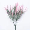 Sprigs of pink and gray artificial lavender flowers on a white background