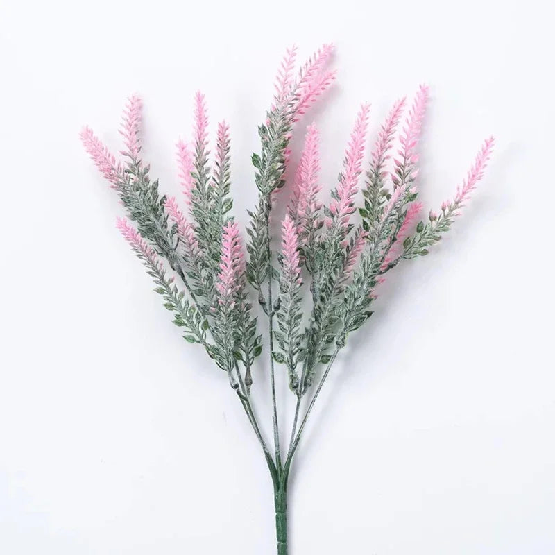 Sprigs of pink and gray artificial lavender flowers on a white background