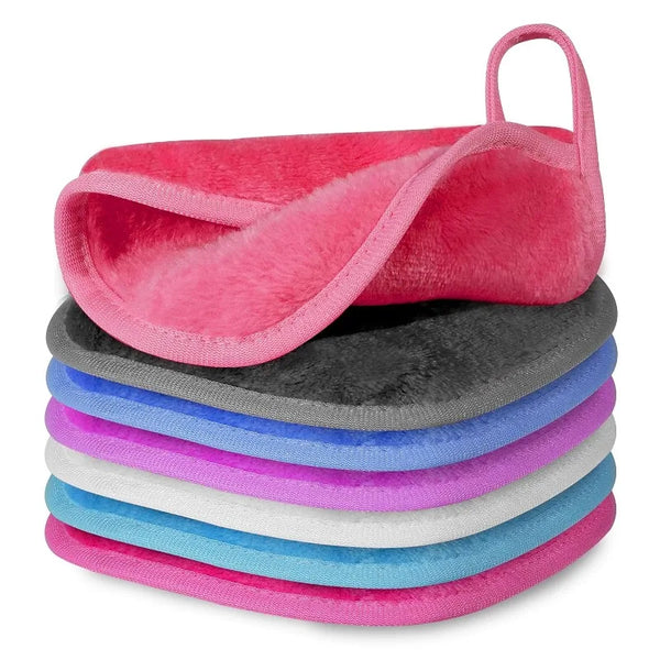 A stack of five reusable makeup remover cloths in various shades of pink, purple, blue, and gray.