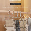 A multi-layer stainless steel clothes rack with hangers and folding pants rack for storage.