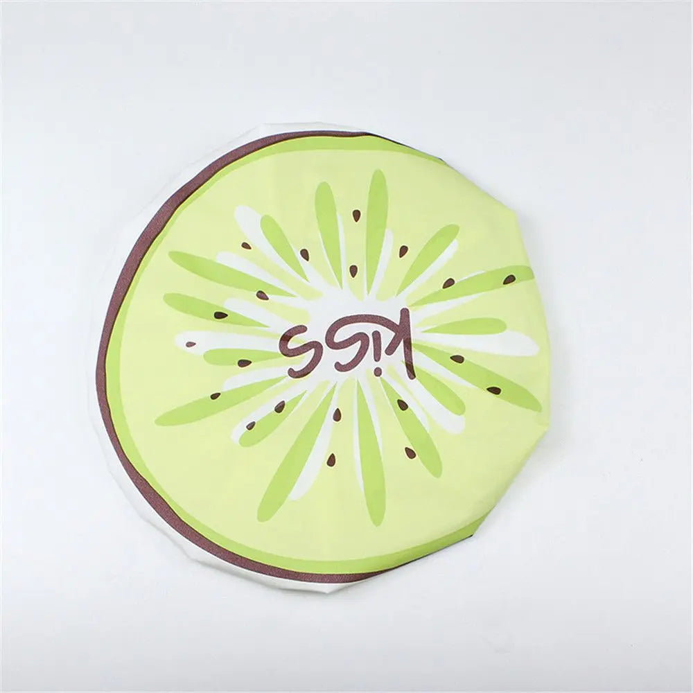 A reusable fruit shower cap shaped like a lime slice with kiwi text and green slices.