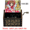 A wooden musical tone box featuring an anime character, labeled 144-B5, with the music title catch you catch me.