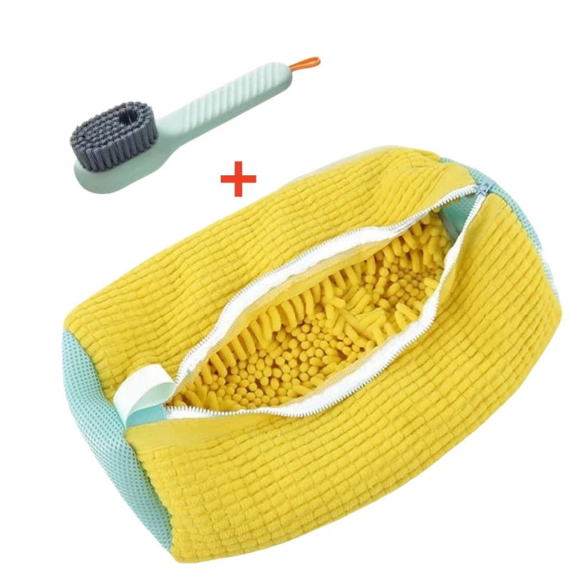 A yellow storage bag for shoes with a white zipper and a small gray brush visible inside.