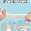 Hands are squeezing a white disposable face towel that is being used for cleaning or absorbing water.