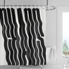 Black and white abstract geometric art shower curtain with wavy stripes hanging on a rod