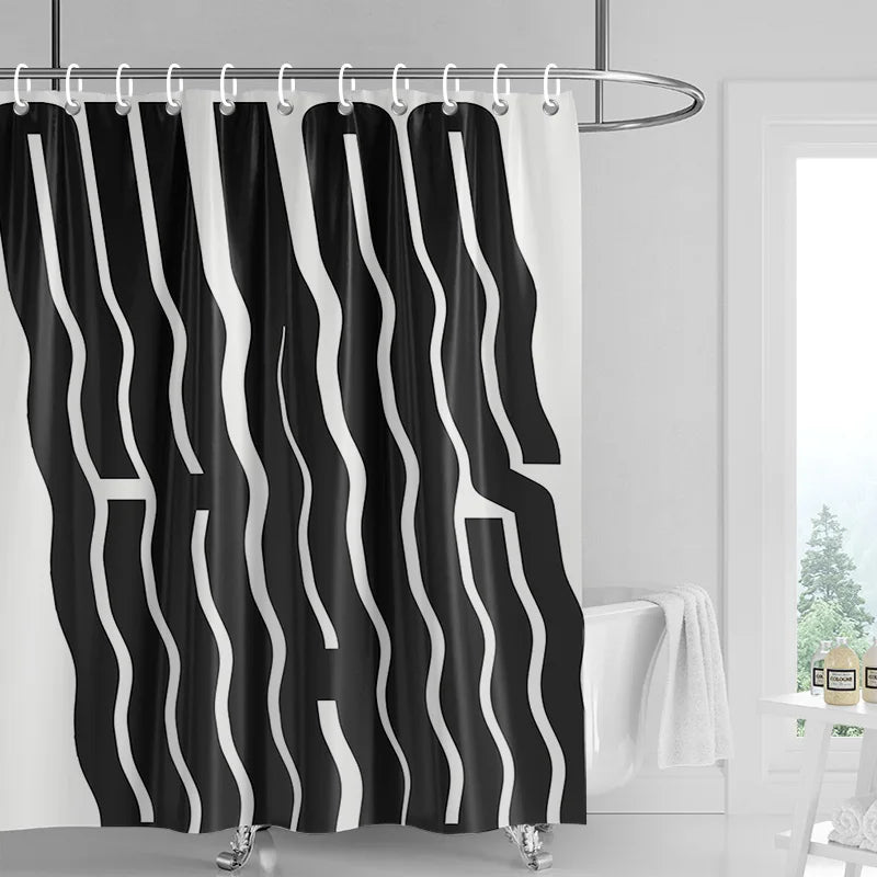 Black and white abstract geometric art shower curtain with wavy stripes hanging on a rod