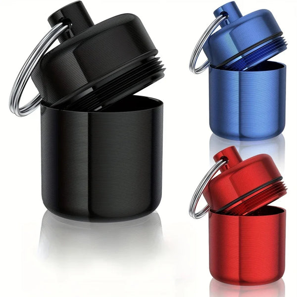 Three aluminum alloy travel pill boxes in black, blue, and red with safety locks shown side by side.