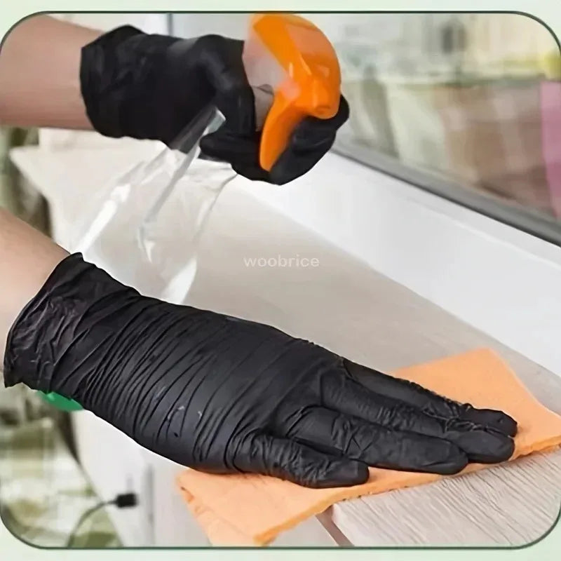A hand wearing a black disposable nitrile glove is using an orange tool to apply product onto an orange cloth.