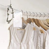 White reusable moisture absorber bags hanging on a wire rack