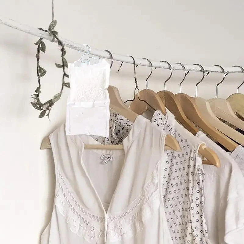 White reusable moisture absorber bags hanging on a wire rack