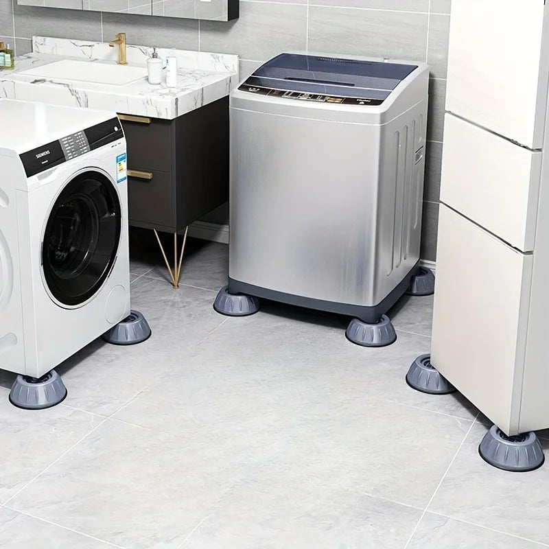 A silver washing machine and a dryer are shown on a tiled floor with anti-vibration pads underneath.