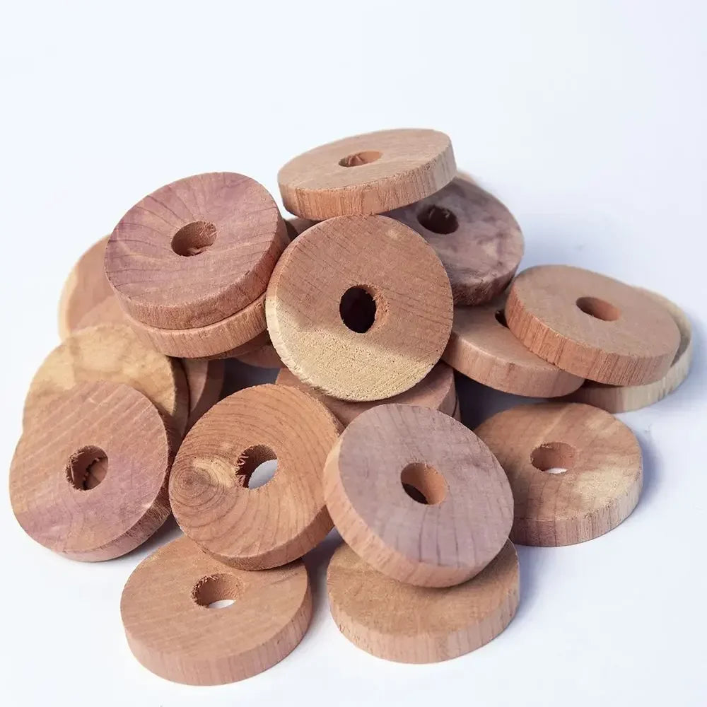 A pile of natural cedar wood blocks used as pest deterrents.