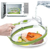 A hand places a food item inside a clear microwave splatter cover, which is being filled with water.