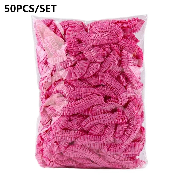A bag of 50 pink reusable transparent shower caps