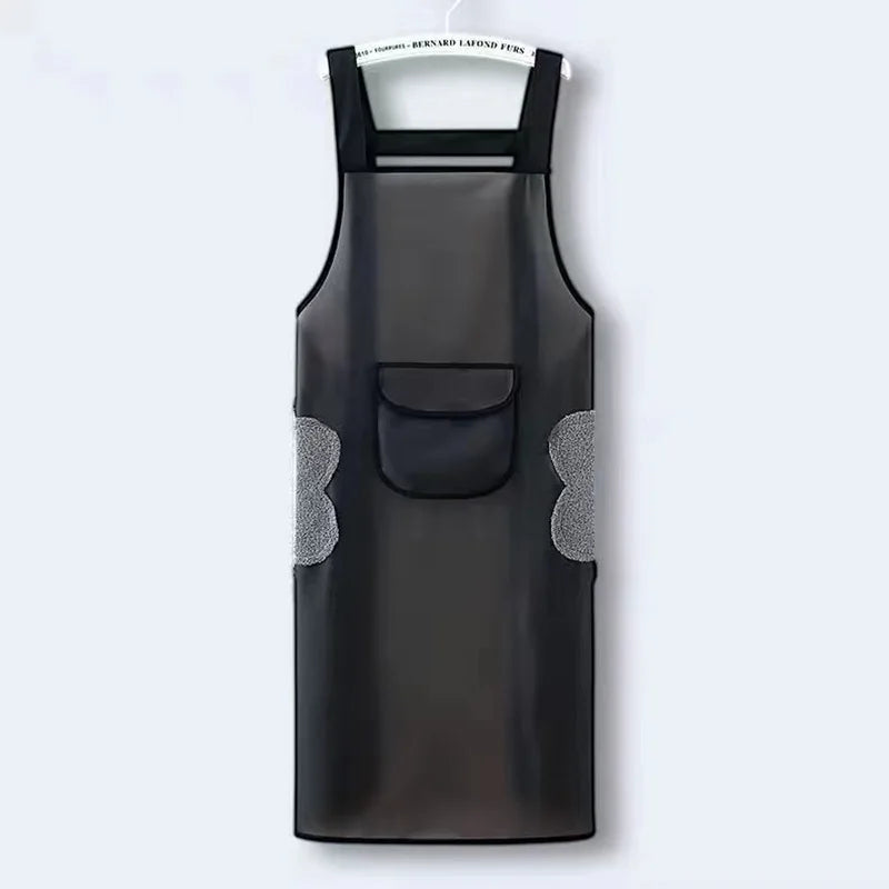 A black waterproof kitchen apron with gray textured accents hanging on a white hanger.