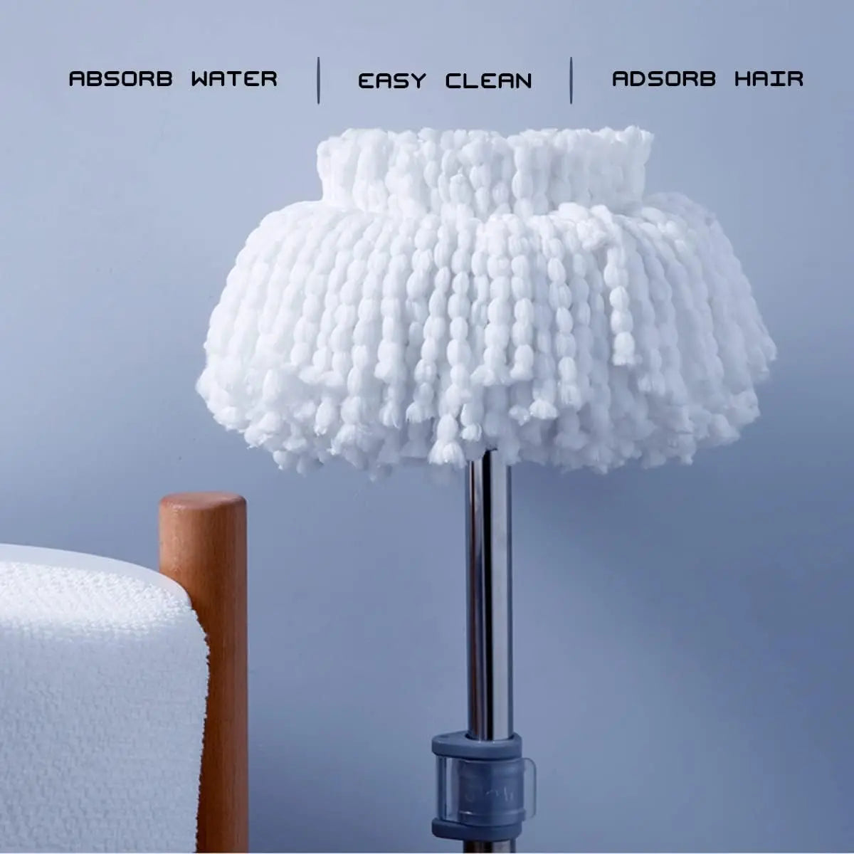 White replacement microfiber spin mop heads with absorbent fibers displayed on a stand.