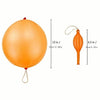 Un ballon à punch en latex orange avec une longue tige et une fine ficelle attachée.