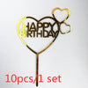 Gold acrylic birthday cake topper with a heart shape and the words HAPPY BIRTHDAY on a stick