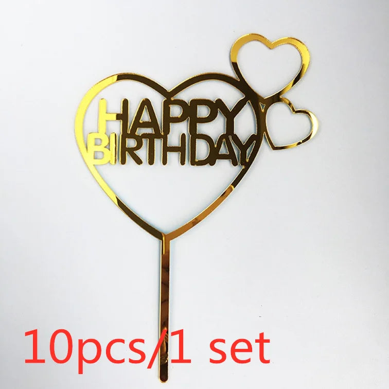 Gold acrylic birthday cake topper with a heart shape and the words HAPPY BIRTHDAY on a stick
