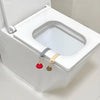 A white portable toilet lid lifter is shown with a red and gold handle mechanism.