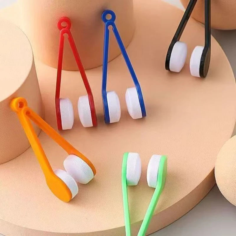 A collection of colorful silicone cleaning tools for eyeglasses, including red, blue, and orange frames.