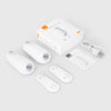 A white motion sensor night light device with a cord and packaging is shown on a light gray background.