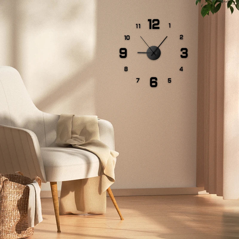 A round black wall clock with Roman numerals hangs on a beige wall next to a light upholstered chair.