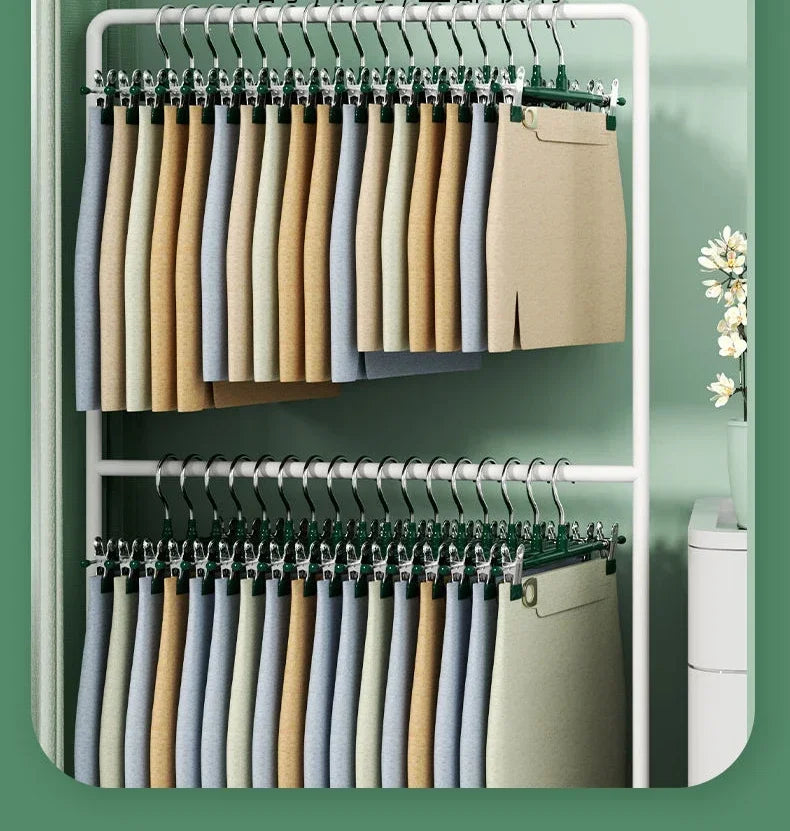 A display of stainless steel adjustable clothing hangers in various neutral and muted earth tones.