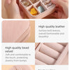 A pink portable jewelry storage box with multiple compartments and a neat car line stitching.