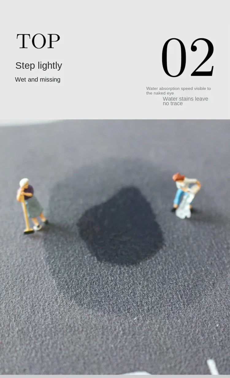 A dark shadow is cast on a gray surface by small figures, demonstrating the water absorption of the mud floor mat.