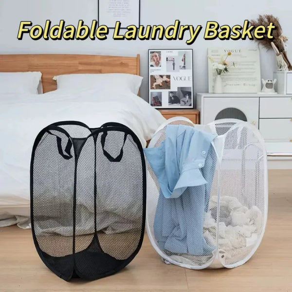 A black foldable mesh laundry basket is shown next to a white, collapsible laundry basket in a bedroom setting.
