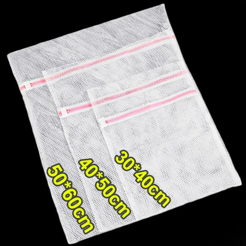 A stack of white mesh laundry bags with pink trim, showing various sizes like 50x60cm and 40x50cm.