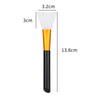 A silicone facial mask brush with a white head and gold handle is shown next to dimension lines.