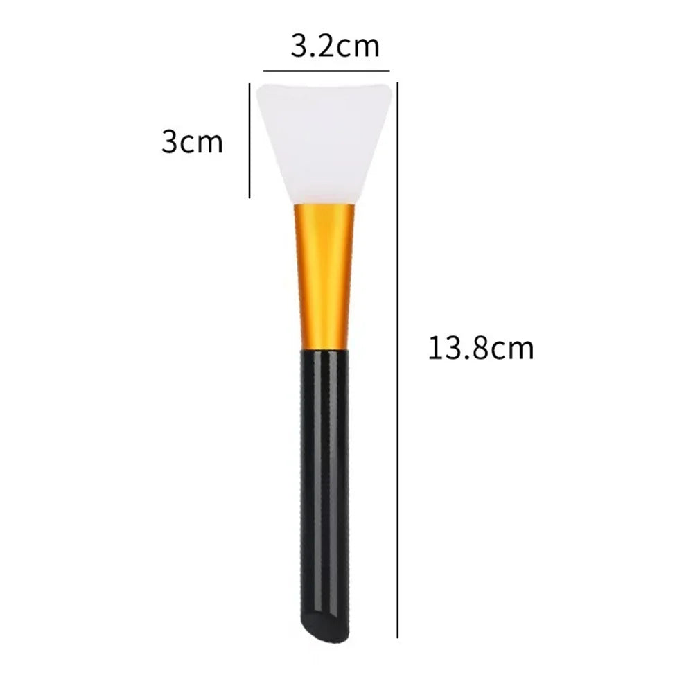 A silicone facial mask brush with a white head and gold handle is shown next to dimension lines.