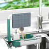 A white and teal adjustable over-sink dish rack organizer holding a blue plaid dishcloth and a brush.