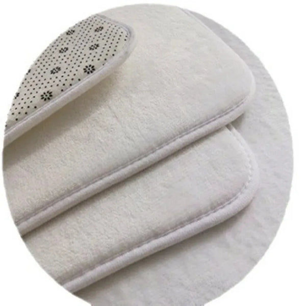 A white, fluffy non-slip kitchen and bathroom mat with a decorative pattern on the edge.