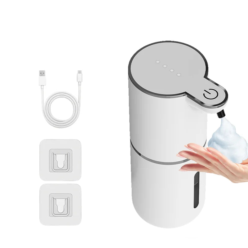 Dispensador de jabón blanco recargable automático con bomba y cable de carga junto a piezas de repuesto.