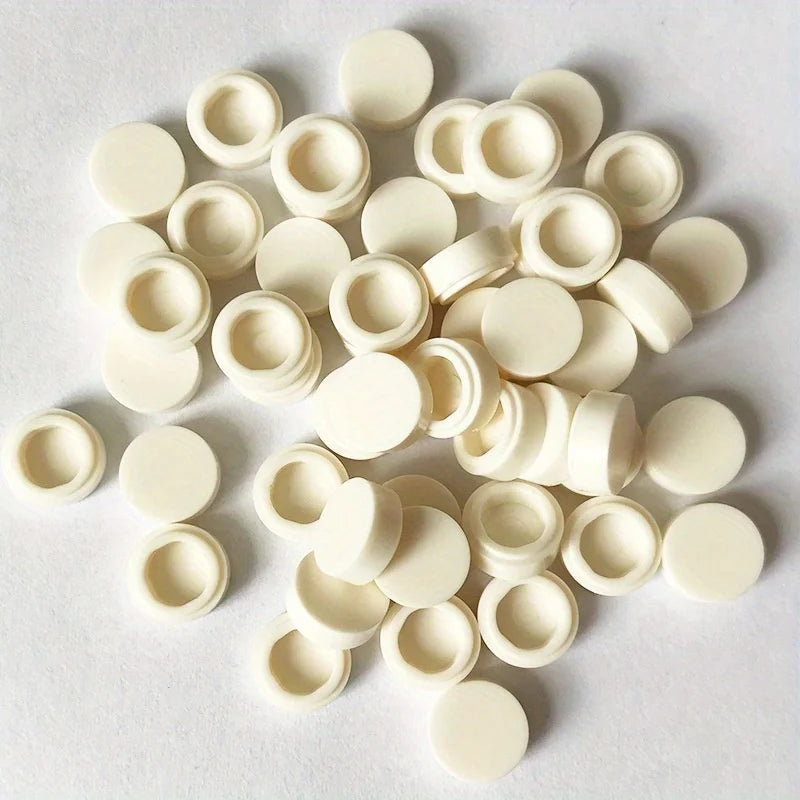A collection of round, off-white building blocks for DIY projects arranged on a white surface.