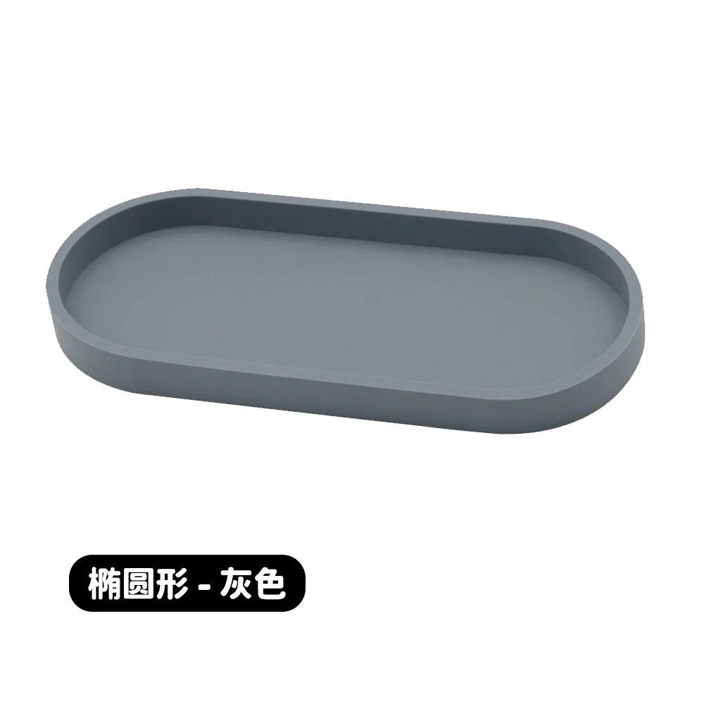 A gray silicone tray organizer with rounded edges.