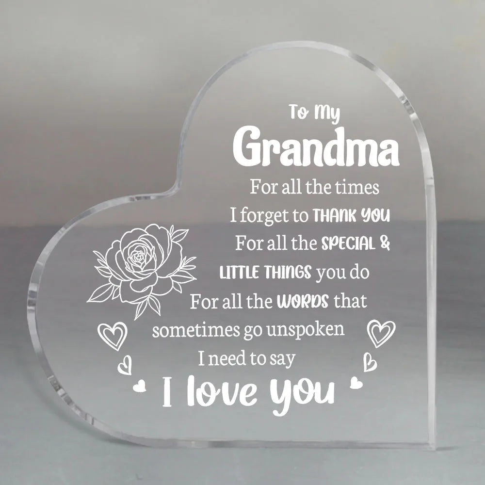 A clear acrylic heart-shaped keepsake engraved with the message I love you to my grandma