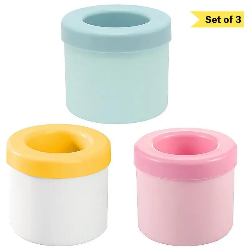 Set of three silicone ice cube molds in light blue, yellow, and pink colors.