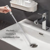 A flexible drain cleaning brush is shown next to a kitchen sink, demonstrating its length and use for cleaning pipes.