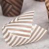 A stack of 50 tulip cupcake liners in striped brown and white paper on a light surface.