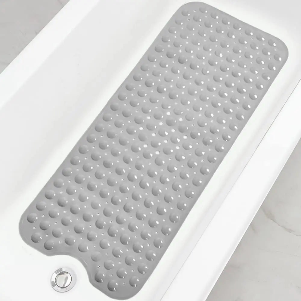 A gray non-slip bathtub mat with suction cups is shown inside a white bathtub.